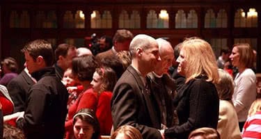 Couples standing closely and holding hands in the Alumni Memorial Chapel