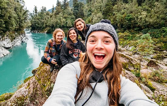 A group of students taking a selfie in the wilderness
